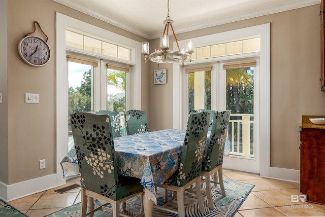 dining space with plenty of natural light, light tile floors, ornamental molding, and a notable chandelier