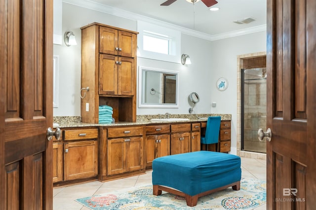 bathroom featuring walk in shower, tile floors, ceiling fan, vanity, and crown molding