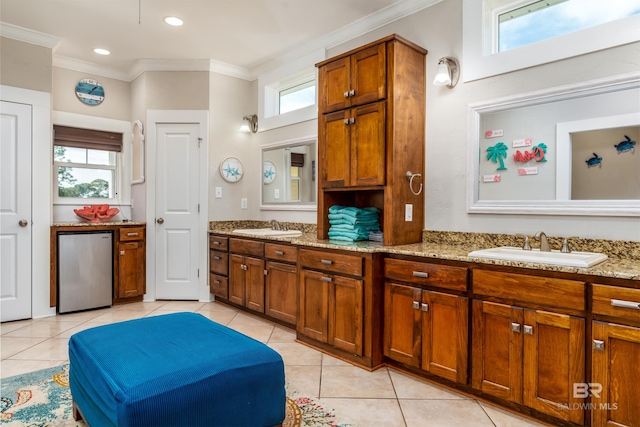 kitchen with plenty of natural light, light stone counters, and light tile floors