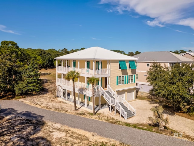 view of front of property featuring a balcony and a garage