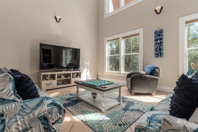 living room featuring light tile floors and a towering ceiling