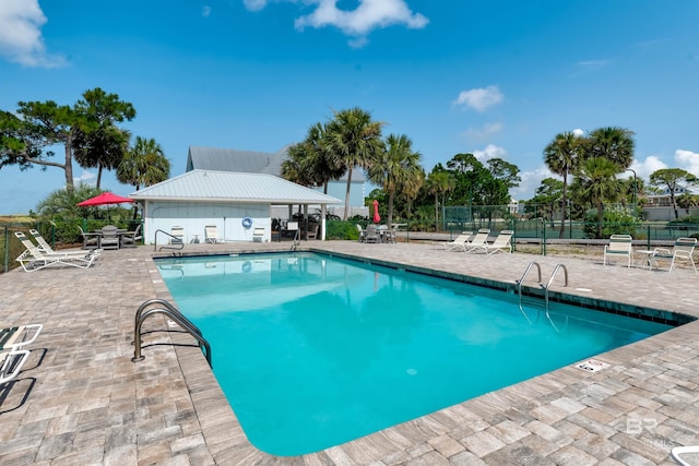 view of swimming pool with a patio area