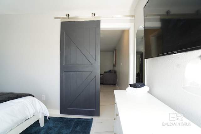 bedroom with light tile patterned flooring and a barn door