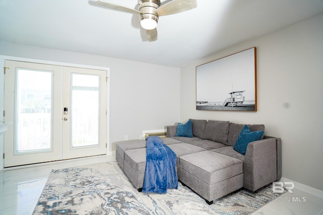 living room featuring ceiling fan and french doors