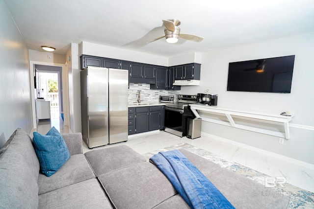 kitchen featuring ceiling fan, appliances with stainless steel finishes, tasteful backsplash, and sink