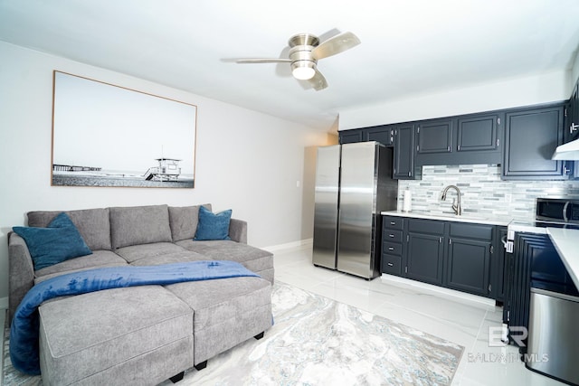 living room with ceiling fan and sink