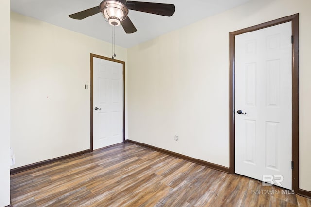 spare room with ceiling fan and dark hardwood / wood-style floors