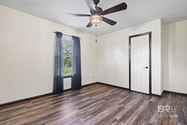 unfurnished room with ceiling fan and dark hardwood / wood-style floors