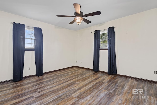 unfurnished room with dark hardwood / wood-style floors and ceiling fan