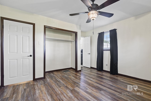 unfurnished bedroom featuring ceiling fan and dark hardwood / wood-style flooring