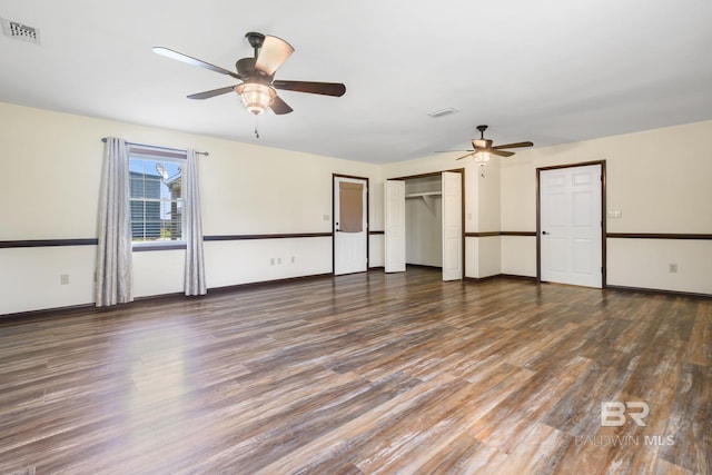 empty room featuring ceiling fan and dark wood-type flooring