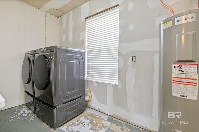 laundry room featuring water heater and independent washer and dryer