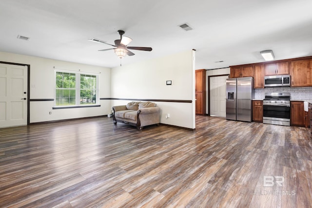 living room with dark hardwood / wood-style flooring and ceiling fan