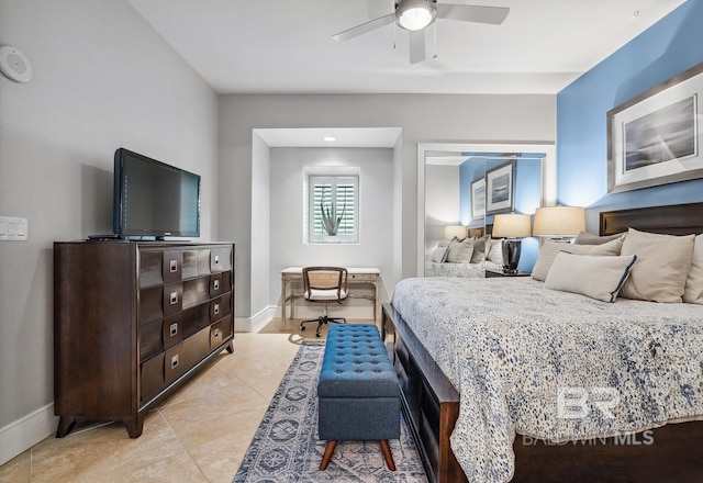 bedroom featuring light tile patterned flooring, baseboards, and ceiling fan