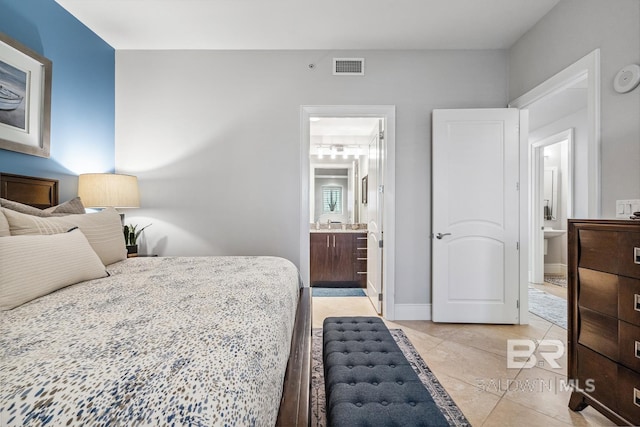 bedroom featuring light tile patterned floors, baseboards, visible vents, and ensuite bathroom