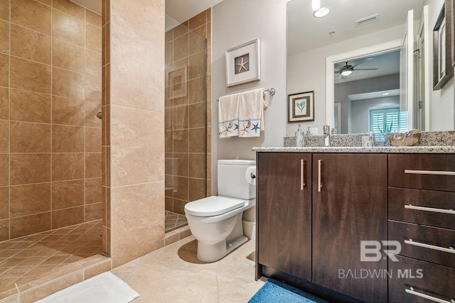 bathroom with visible vents, ceiling fan, toilet, a stall shower, and vanity