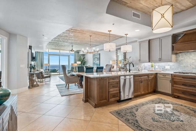kitchen with visible vents, a peninsula, stainless steel appliances, expansive windows, and tasteful backsplash