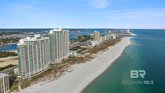 drone / aerial view with a beach view, a view of city, and a water view