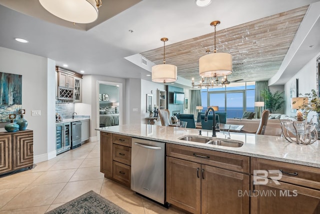kitchen with backsplash, open floor plan, dishwasher, light tile patterned flooring, and a sink
