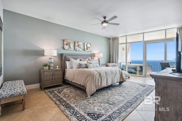 bedroom with light tile patterned floors, baseboards, ceiling fan, access to exterior, and floor to ceiling windows