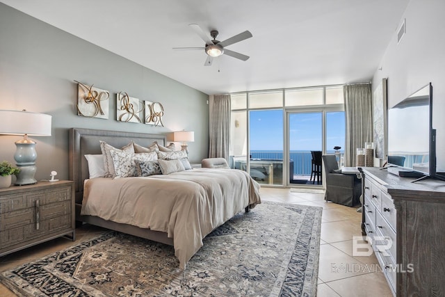 bedroom featuring access to exterior, visible vents, ceiling fan, expansive windows, and light tile patterned floors