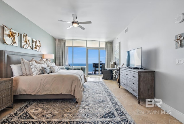 bedroom featuring access to exterior, visible vents, baseboards, expansive windows, and light tile patterned floors