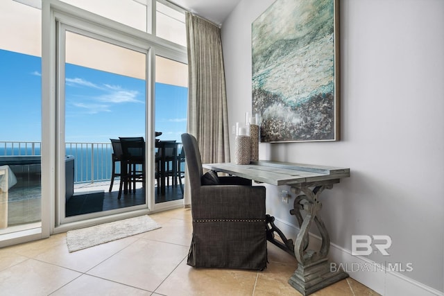 dining area with light tile patterned flooring and baseboards