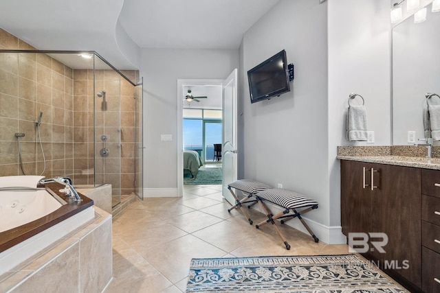 bathroom featuring tile patterned floors, a stall shower, a jetted tub, ceiling fan, and vanity