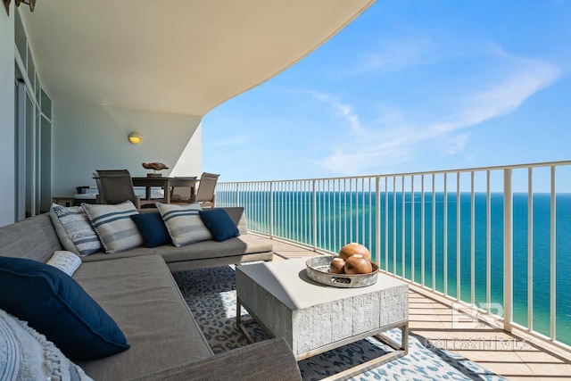 balcony featuring outdoor lounge area and a water view