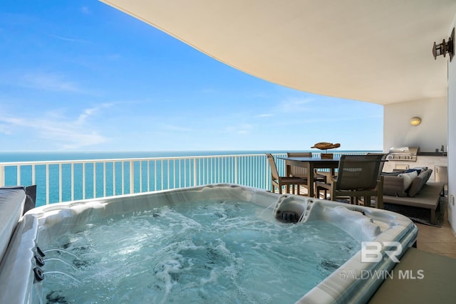 view of pool featuring a water view and a hot tub