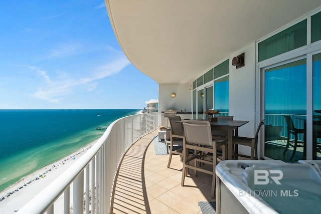 balcony with a water view and a beach view