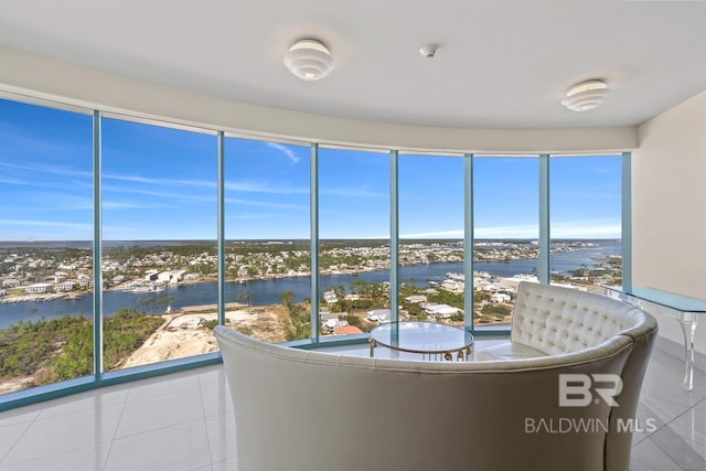 unfurnished sunroom featuring a water view