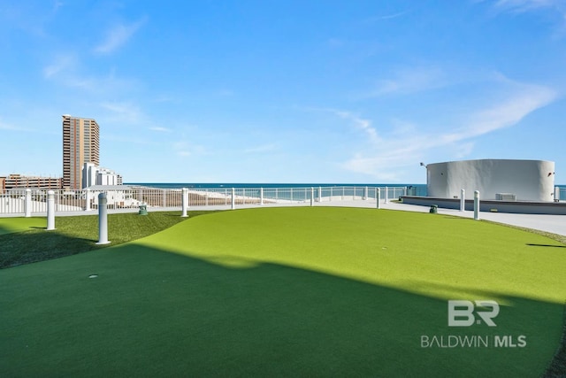 view of property's community featuring fence and a water view