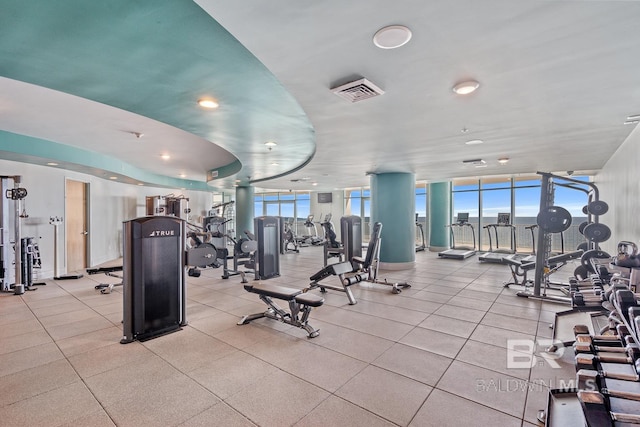 gym featuring visible vents and expansive windows