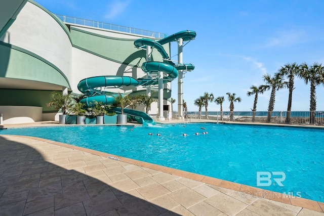 view of pool featuring a patio area and a water slide