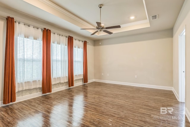 24774 Smarty Jones Cir, Daphne, AL 36526 - empty room featuring a tray ceiling, dark wood-type flooring, ceiling fan, baseboards, and ornamental molding