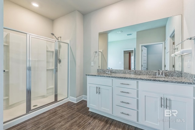 24774 Smarty Jones Cir, Daphne, AL 36526 - full bathroom featuring a stall shower, wood finished floors, double vanity, and baseboards