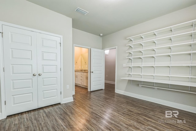 24774 Smarty Jones Cir, Daphne, AL 36526 - unfurnished bedroom with baseboards, dark wood-style floors, and a closet