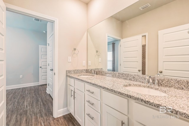 24774 Smarty Jones Cir, Daphne, AL 36526 - bathroom featuring wood finished floors, double vanity, and baseboards