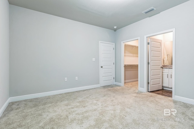 24774 Smarty Jones Cir, Daphne, AL 36526 - unfurnished bedroom with carpet floors, a spacious closet, baseboards, a closet, and connected bathroom