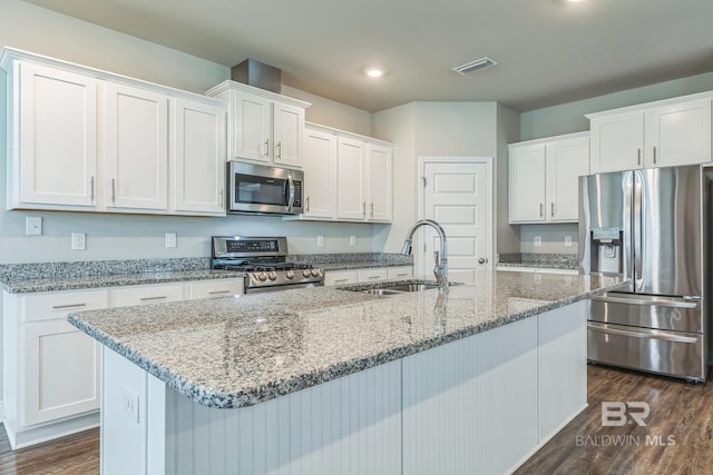 24774 Smarty Jones Cir, Daphne, AL 36526 - kitchen with stainless steel appliances, a sink, white cabinets, dark wood finished floors, and a center island with sink
