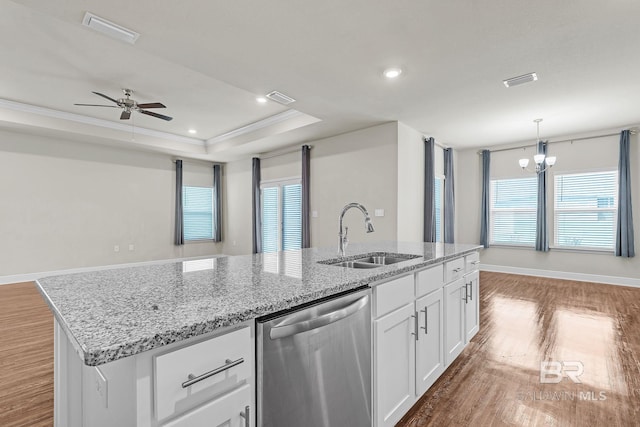 24774 Smarty Jones Cir, Daphne, AL 36526 - kitchen with stainless steel dishwasher, a sink, wood finished floors, white cabinetry, and plenty of natural light