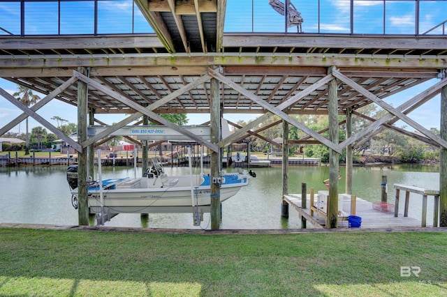 view of dock with a yard and a water view