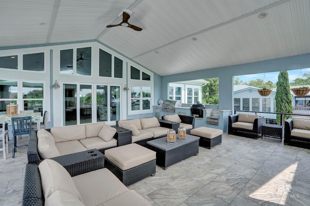 sunroom / solarium with ceiling fan and vaulted ceiling