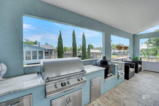 view of patio with area for grilling and an outdoor kitchen