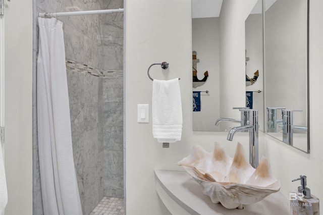 bathroom with curtained shower and sink