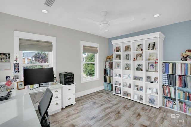 office space featuring ceiling fan and light wood-type flooring