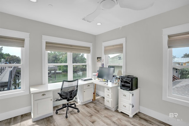 office space with plenty of natural light and light hardwood / wood-style flooring