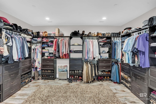 spacious closet with light hardwood / wood-style floors