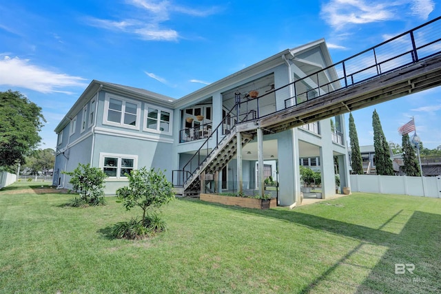 rear view of house with a patio area and a lawn